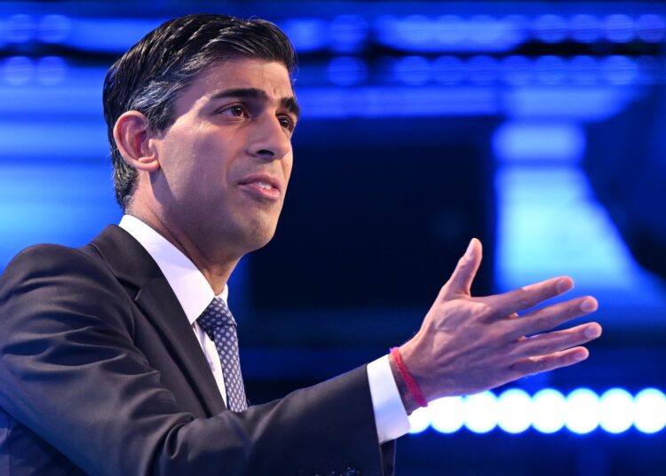 Britain's Prime Minister Rishi Sunak gestures as he delivers a speech at the Confederation of Business Industry (CBI) annual conference at the Vox Conference Centre in Birmingham on November 21, 2022. - The UK's recent austerity budget may avert a deeper recession, but the government must focus more on growth to improve the country's long-term prospects, the CBI will say. (Photo by Oli SCARFF / AFP)